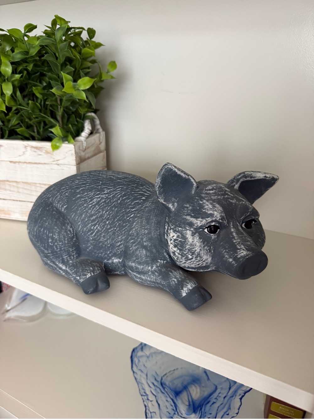 Lying Down Pig Statue Styled as a Rustic Farmhouse Decorative Piece
